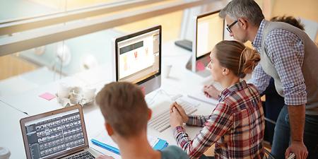 Students learning Photoshop and practicing in front of computers in Photoshop bootcamp course.