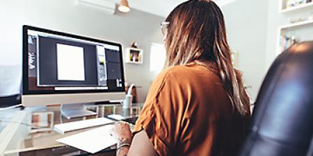 Adobe Illustrator bootcamp student working at a computer.