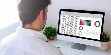 Student attending an Excel course looking at a spreadsheet on a computer screen.